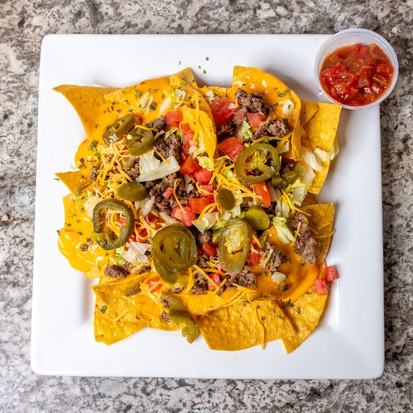 DaBomb Sports Grill's nachos with ground beef, cheese sauce, jalapeños, tomatoes, and lettuce.